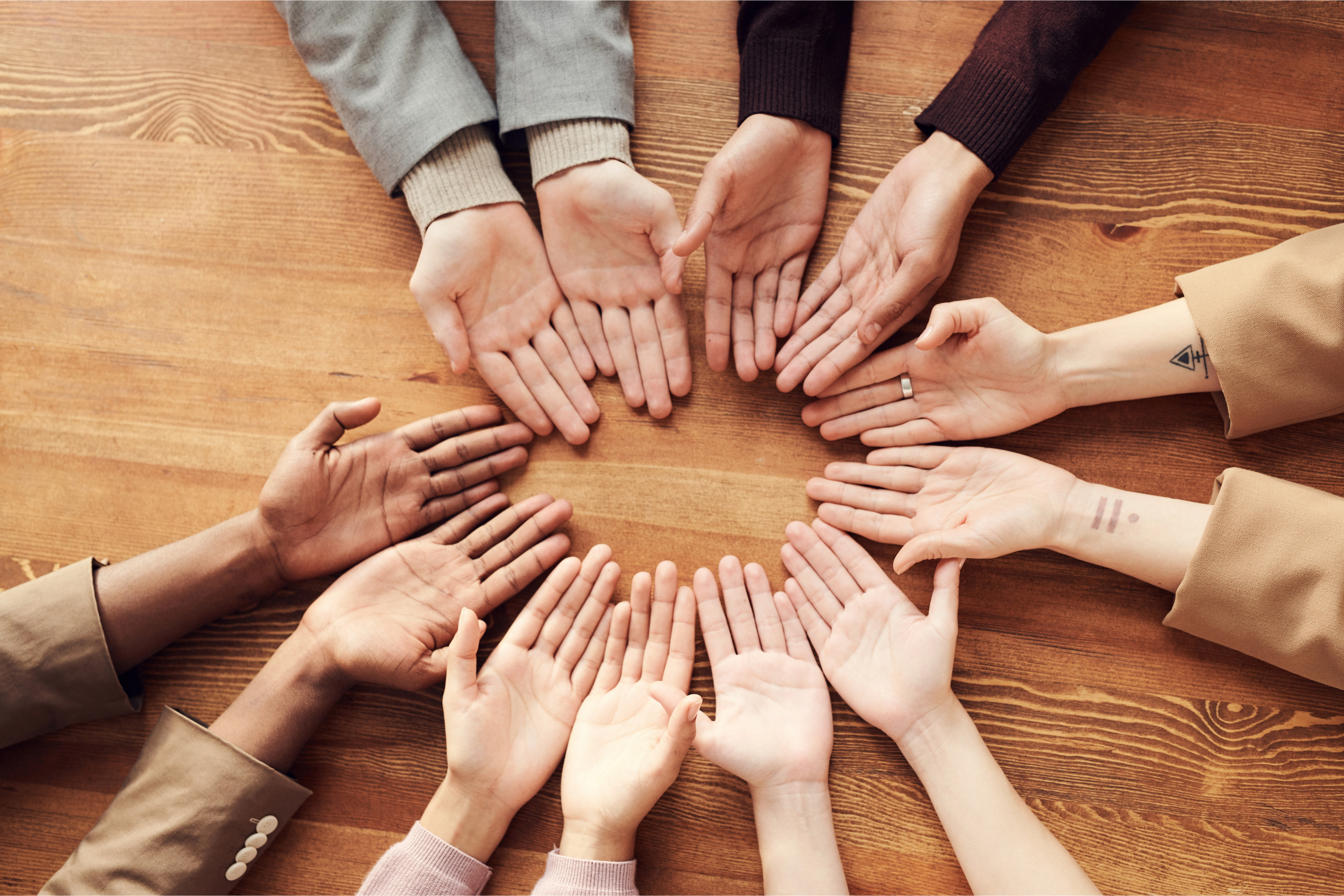 Children's hands facing palm up in a circle