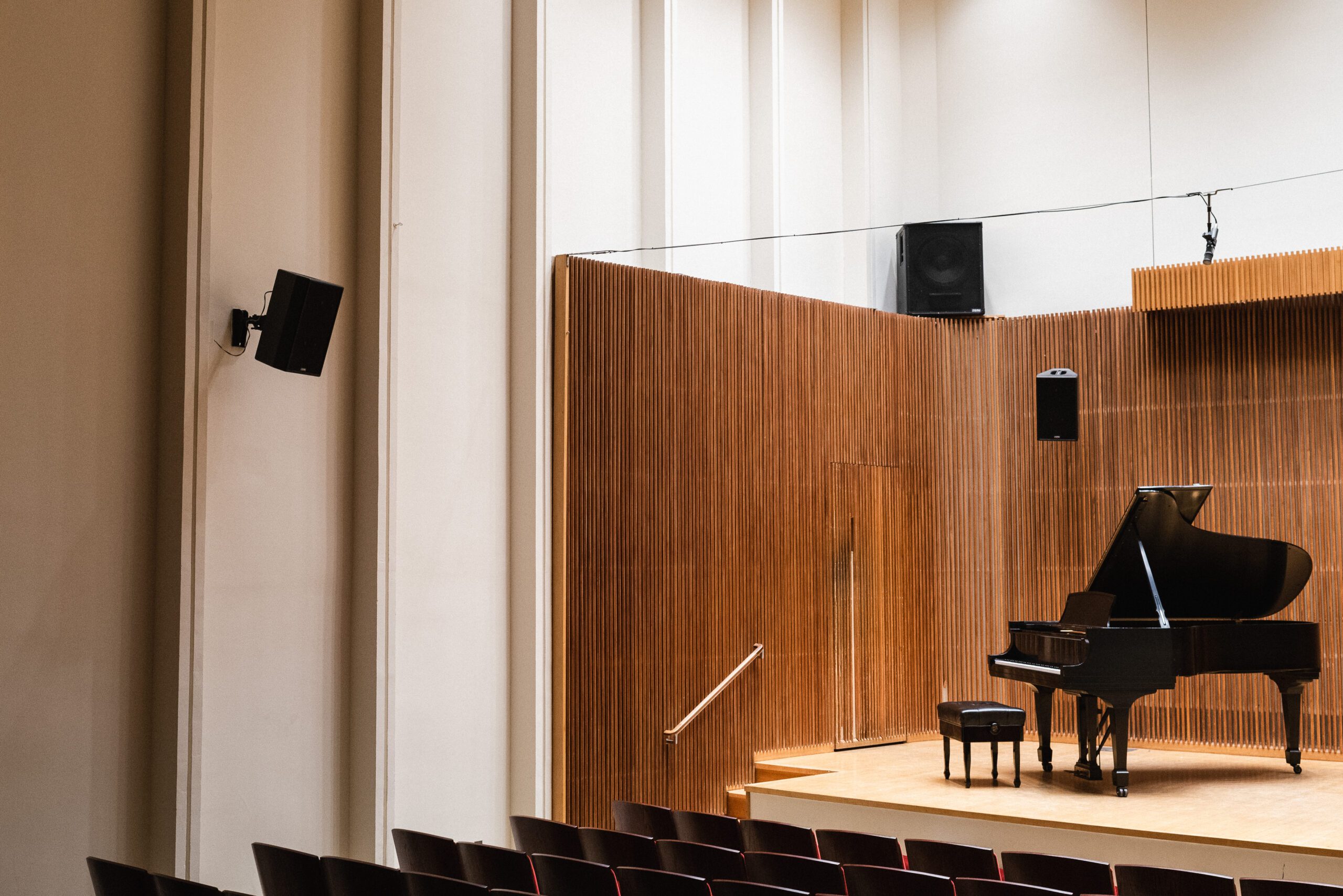 A grand piano on a recital stage.